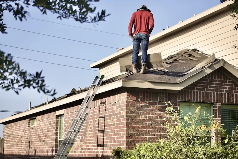 Professional roofer working on a residential roof in East Lyme